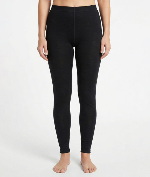 Black base layer pants. Merino Pants are made of 100% merino wool and should be worn during activities where extra warmth and good moisture transport are needed.  The image shows a female model from the front.