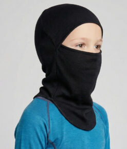 Bagheera black Balaclava in 100% merino wool for half or full face protection. The picture shows a 6 year old boy model from the front.
