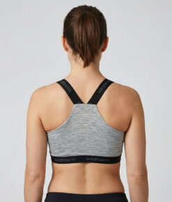 The Merino Sports Bra is a light grey soft and comfortable sports bra with light support. The unique properties of merino wool mean that it keeps you warm even when you sweat, which gives you a comfortable feeling.  The image shows a female model from behind.