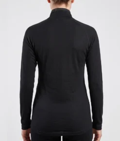 Kvinlig modell visar en svart långärmad polo underställströja i 100% merinoull. Modellen visar tröjan bakifrån mot en ljusgrå bakgrund.