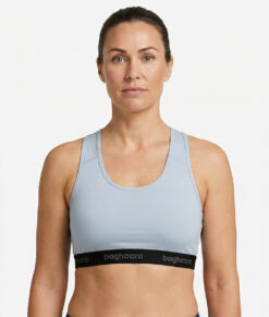 Light grey Sports Bra is made of compression fabric that provides proper support for fast-paced forms of exercise that involve a lot of movement. The image shows a female model from the front.