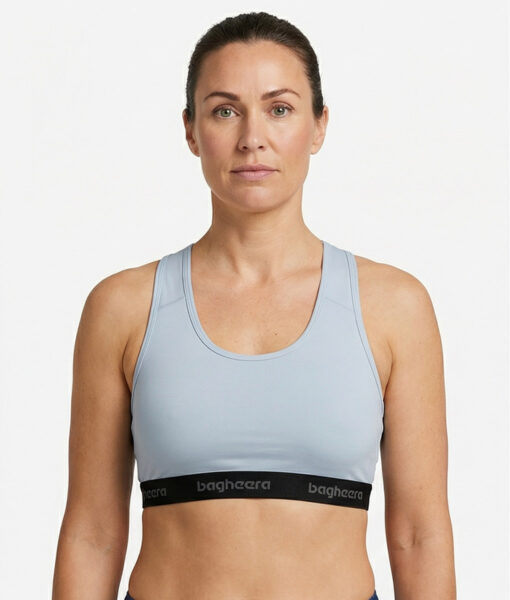 Light grey Sports Bra is made of compression fabric that provides proper support for fast-paced forms of exercise that involve a lot of movement. The image shows a female model from the front.