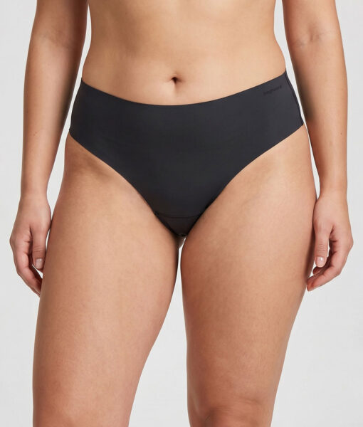 Female model shows off a pair of black Swift Thong women's thongs. The image shows the model from the front in a studio with a light gray background.