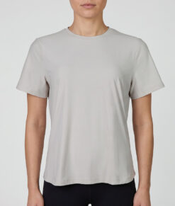Female model showing off a white Bagheera t-shirt. The model is shown from the front in a studio against a light gray background.