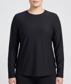 Female model shows off a black Bagheera long-sleeved tracksuit. . The model is shown from the front in a studio against a light gray background.