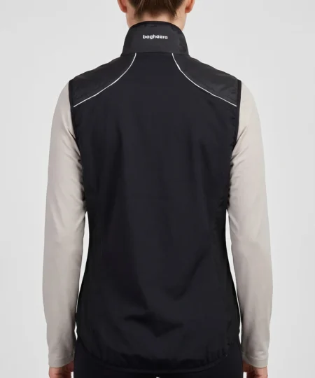 Kvinlig modell visar en svart fleece väst Modellen visar västen bakifrån i en studio med ljusgrå bakgrund.